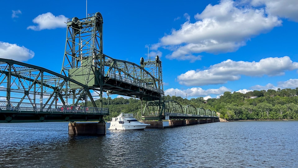 Illustrative small-town hero photograph, a lift bridge over a river at dusk