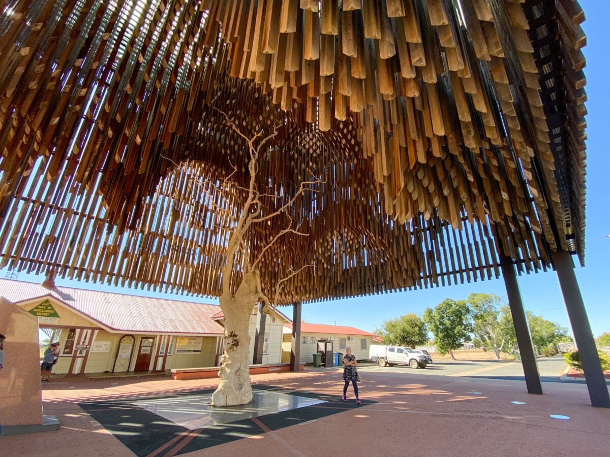 The Tree of Knowledge Memorial in Barcaldine, Queensland, a dark timber structure enclosing the preserved trunk of the original tree.