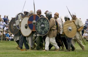Costumed Viking reenactors with painted round shields in Gimli, Manitoba.
