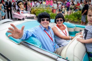 Elvis impersonators and crowds along a street in Parkes, New South Wales, during the Parkes Elvis Festival.