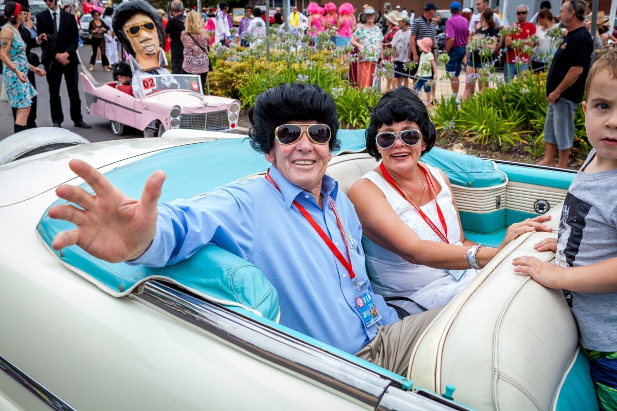 Elvis impersonators and crowds along a street in Parkes, New South Wales, during the Parkes Elvis Festival.