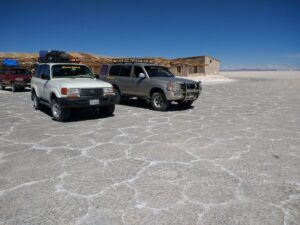 Vehicles in front of a salt hotel in the Salar de Uyuni.
