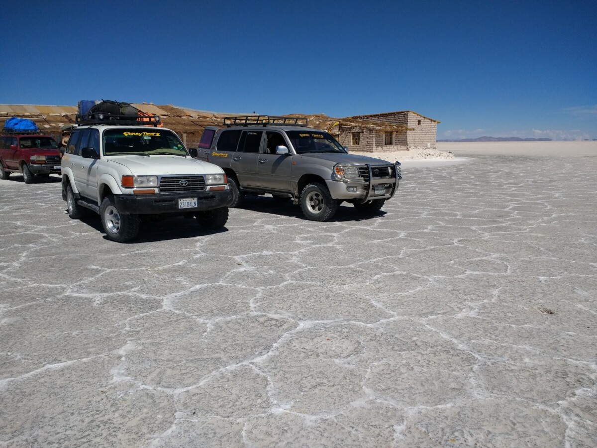 Vehicles in front of a salt hotel in the Salar de Uyuni.